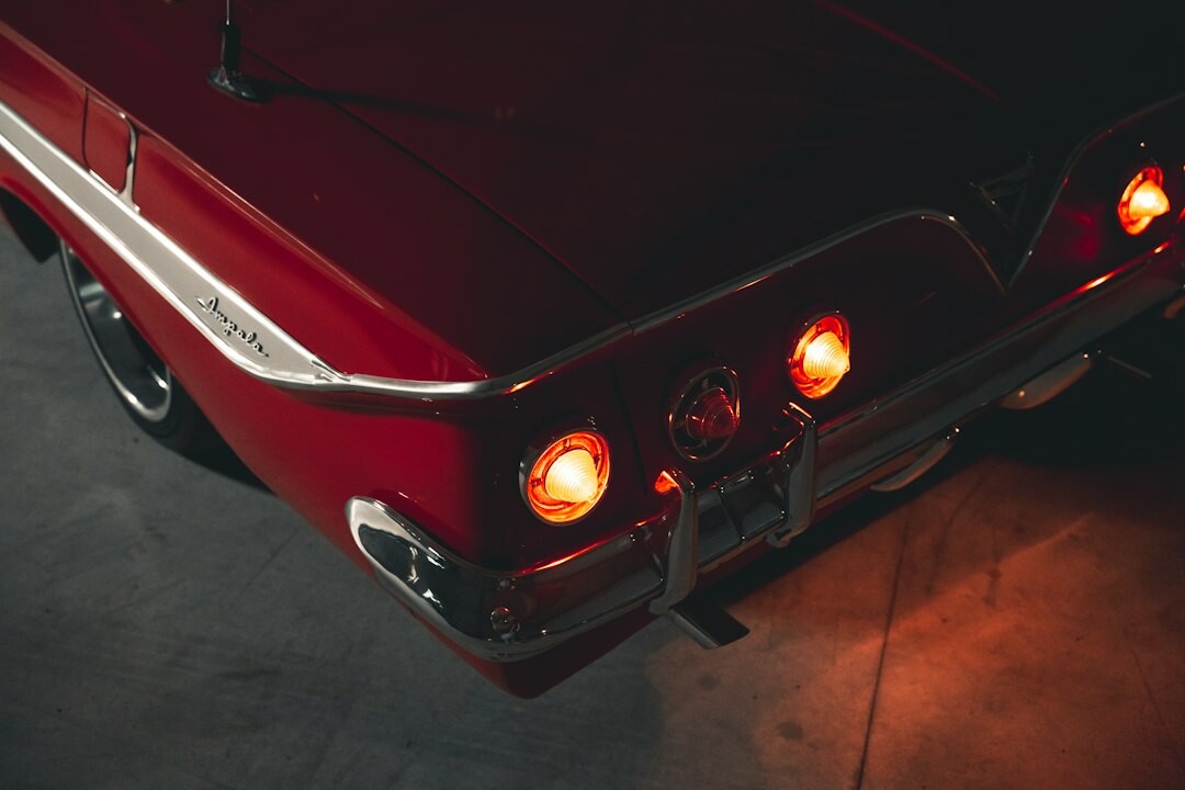 Restored vintage automobile photographed in a studio against a dark backdrop