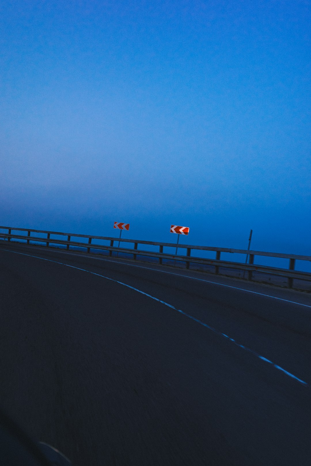 Modern hypercar photographed on an empty highway at dawn