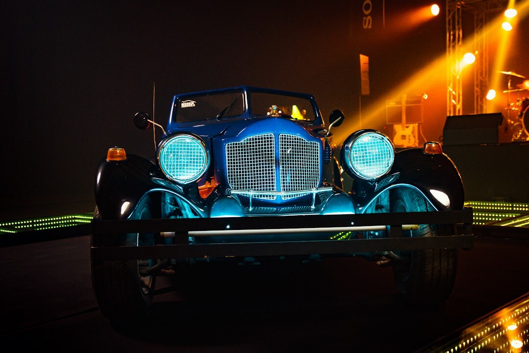 Elegant automobile auction event with a spotlighted classic car on stage