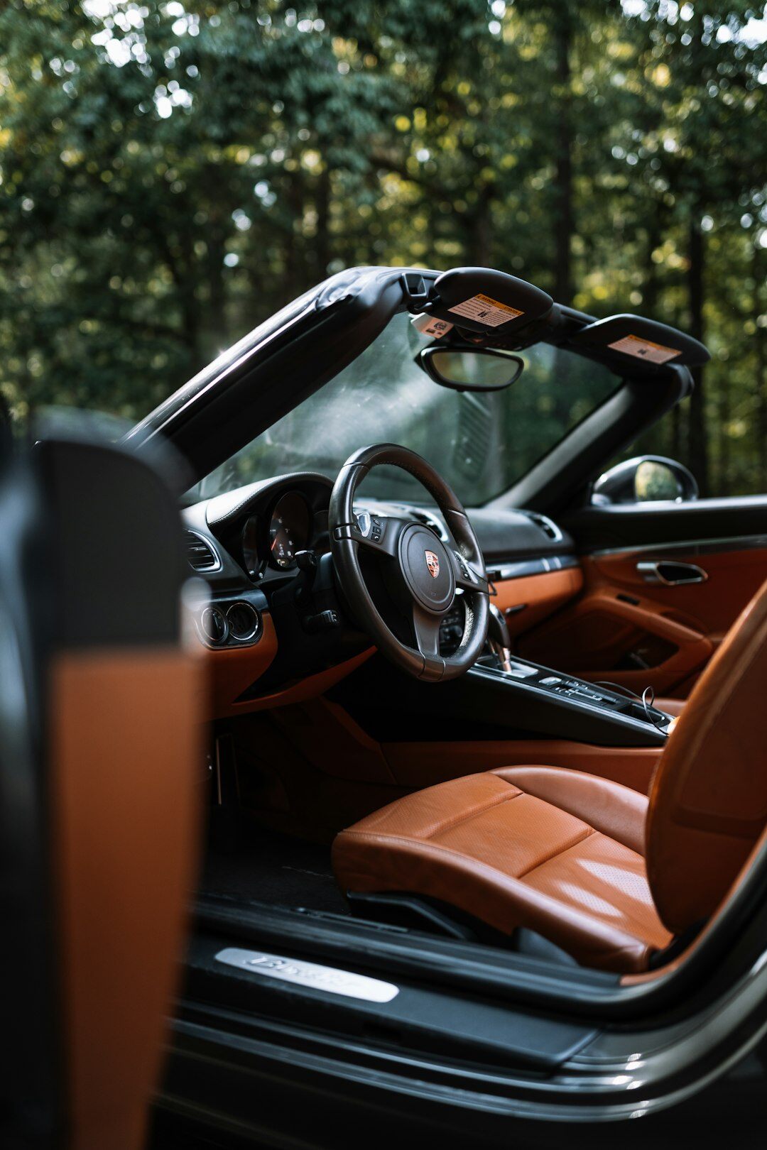 Close-up studio photograph of a luxury car interior with leather seats and dashboard